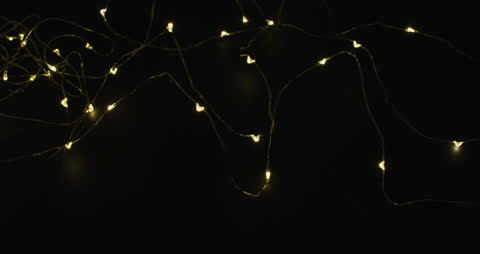 Glowing Fairy Lights on Black Background Creating Magical Atmosphere