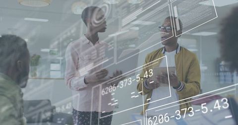 Colleagues collaborating with augmented reality interface in open-plan tech office