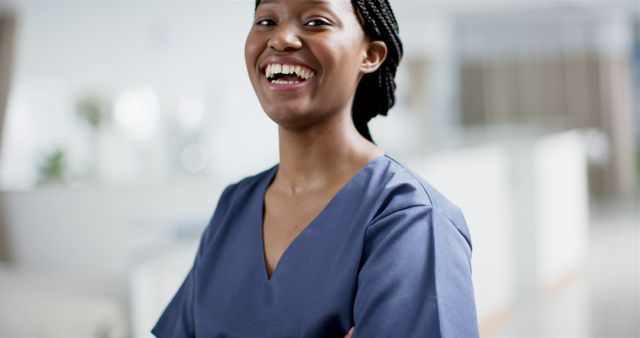 Smiling Healthcare Professional in Blue Scrubs Standing Confidently - Download Free Stock Images Pikwizard.com