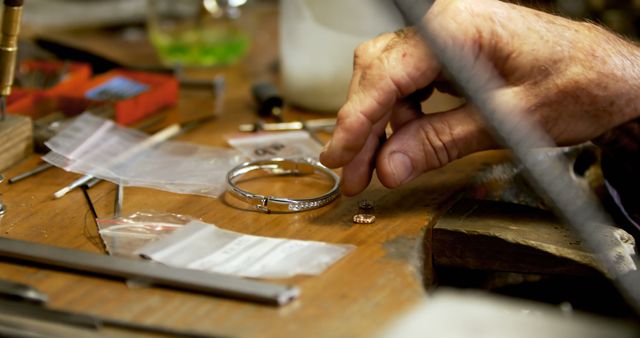 Artisan Handcrafting Silver Jewelry on Workbench - Download Free Stock Images Pikwizard.com