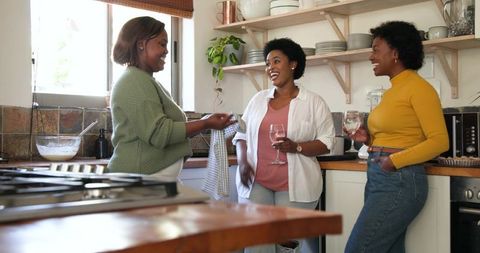 African American Women Socializing in Cozy Kitchen Setting