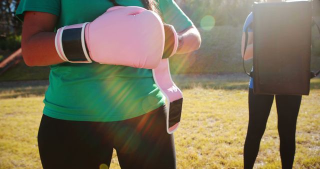 Woman with Boxing Gloves Practicing Outdoor in Sunlight Field - Download Free Stock Images Pikwizard.com