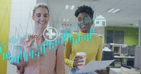 Reviewing interactive financial data overlay while colleagues holding coffee and reports