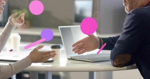 Colleagues collaborating over laptop and coffee with creative abstract graphic overlays