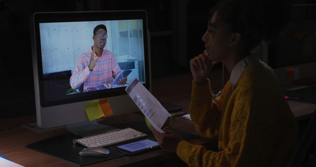 Young African American man on a computer screen in a dark office - Download Free Stock Photos Pikwizard.com