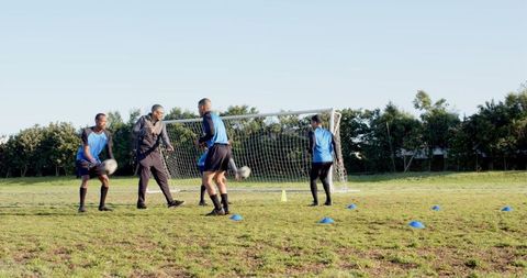 Men Engaging in Soccer Training Drill Session Outdoors