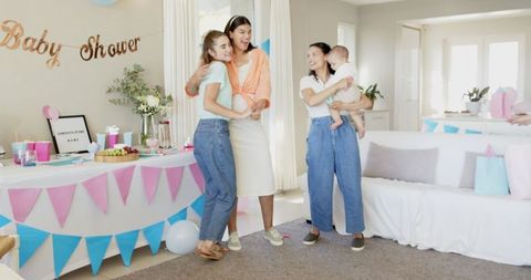 Joyful Multiracial Women Celebrating Baby Shower with Laughter