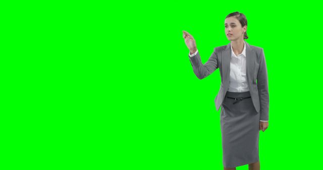 Confident Businesswoman in Gray Suit Gesturing on Green Screen Background - Download Free Stock Images Pikwizard.com