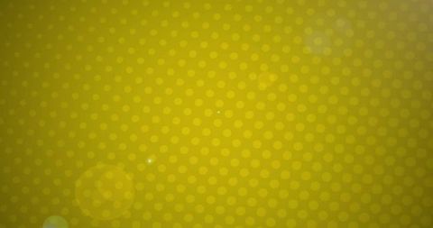 Polka dot pattern on vibrant yellow backdrop