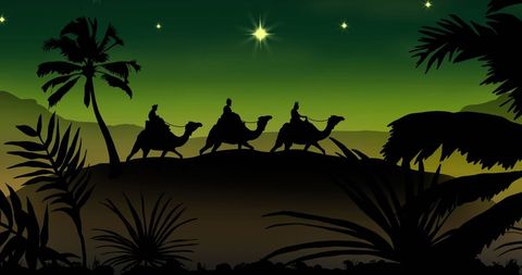 Silhouette of three wise men traveling on camels at night