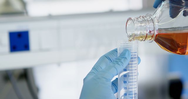 Scientist Wearing Gloves Pouring Liquid into Graduated Cylinder in Laboratory - Download Free Stock Images Pikwizard.com