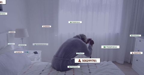 Stressed man holding head in modern bedroom with overlay data