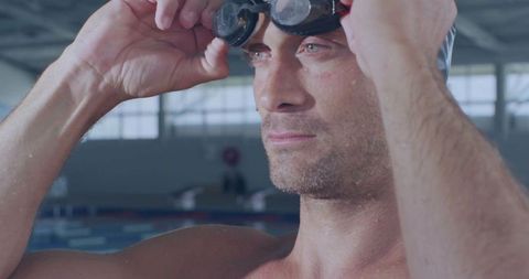 Swimmer Adjusting Goggles in Indoor Track with Focused Look