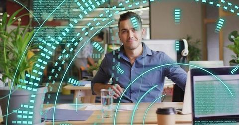 Young professional using laptop with futuristic digital interface overlay in modern office