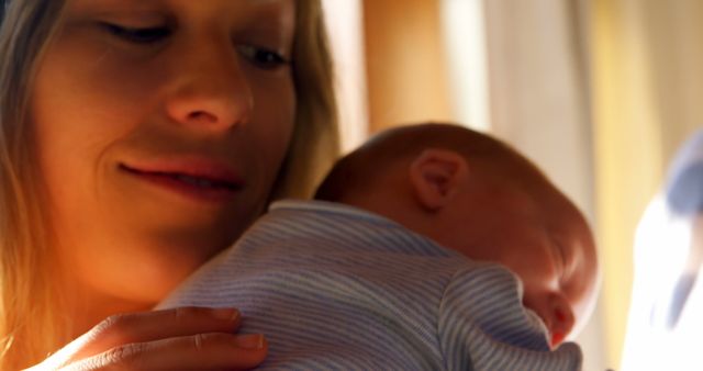 Happy Mother Holding Newborn Baby in Sunlight - Download Free Stock Images Pikwizard.com