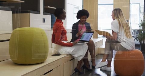 Diverse Team Collaborating in Modern Office with Financial Graphics