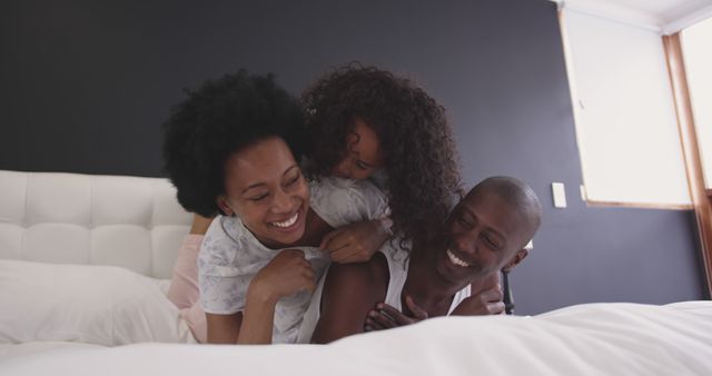 Joyful Family Playing on Bed in Cozy Bedroom - Download Free Stock Images Pikwizard.com