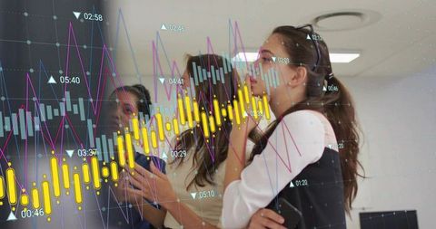 Female Analyst Studying Financial Candlestick Charts with Team Collaboration in Office