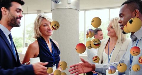 Business professionals networking with floating emoji