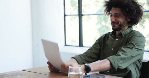 Smiling Professional Reading Document in Modern Office Meeting