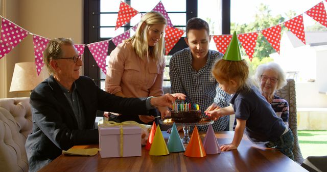 Use this vibrant stock photo to represent family gatherings, birthday celebrations, and happy moments across generations. Perfect for promoting celebrations, party supplies, family-oriented products, or any content highlighting love and togetherness within a family setting.