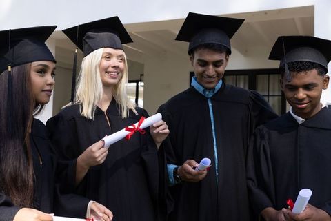 Diverse graduates in caps and gowns celebrating achievement