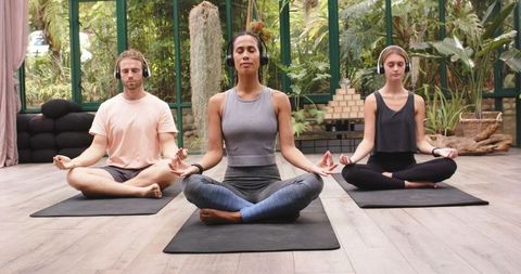 Mindful meditation in serene glasshouse yoga studio