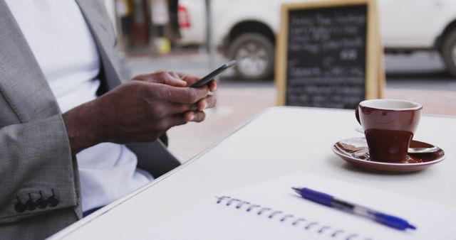 Man Using Smartphone at Outdoor Cafe with Coffee on Table - Download Free Stock Images Pikwizard.com