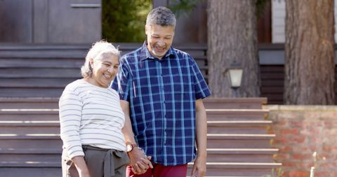 Happy Senior Couple Enjoying Sunny Garden Walk