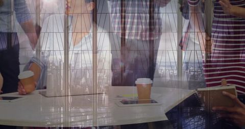 Business Team Collaborating with City Skyline Reflection