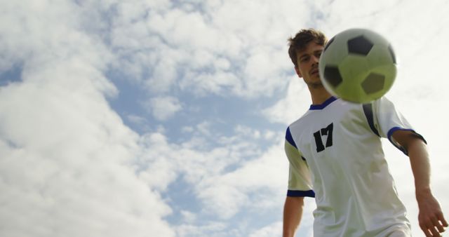 Soccer Player Practicing with Ball Against Blue Sky - Download Free Stock Images Pikwizard.com