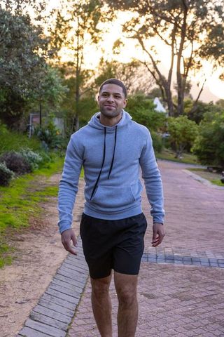 Man Walking Through Park in Fresh Sunset Ambiance