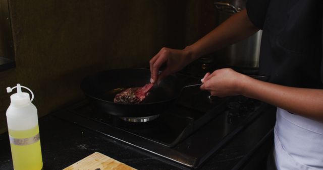 Chef Cooking Steak on Stove in Dimly Lit Kitchen - Download Free Stock Images Pikwizard.com