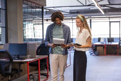 Diverse Team Analyzing Reports in Modern Office Environment