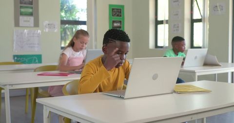 Schoolchildren Working on Laptops in Classroom Black Boy Concentrating on Online Learning