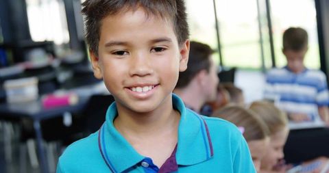 Smiling Schoolboy in Turquoise Polo Shirt Enjoying Learning Environment