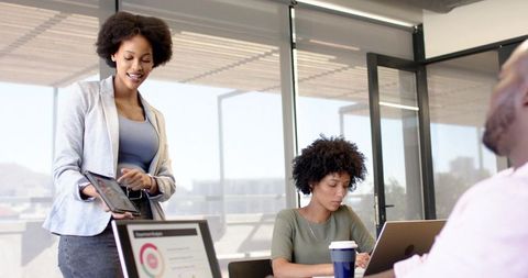 Diverse Coworkers Engaging in Productive Team Collaboration in Modern Office