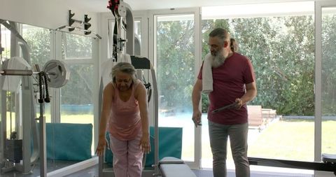 Senior Couple Staying Active Stretching Together at Home Gym