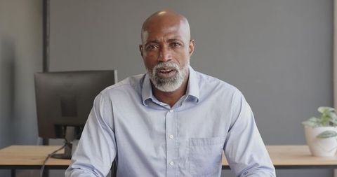 Confident Businessman Engaging in Video Call in Office