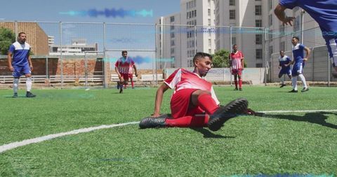 Energetic soccer player in red executing a skillful tackle
