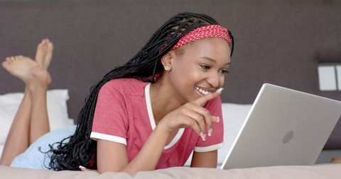 African American Woman Using Laptop at Home Smiling Relaxed