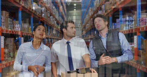 Diverse team analyzing digital data in warehouse environment