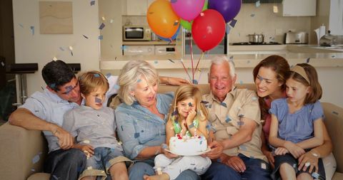 Happy Caucasian Family Celebrating a Balloon-Filled Party at Home