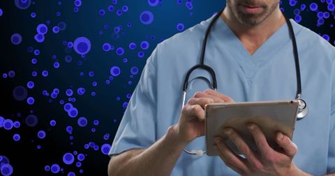 Medical professional using tablet with digital cells background