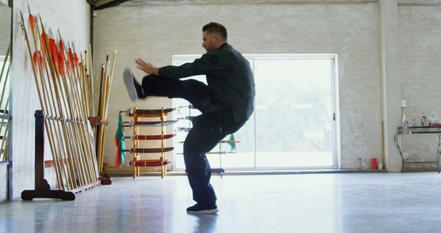 Martial Artist Practicing Kicking Technique in Dojo - Download Free Stock Images Pikwizard.com