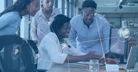 Collaborative team designing connected WiFi network at modern office workstation