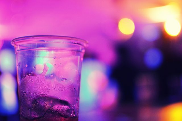 Nightlife enthusiasts and event organizers will find this image perfect for promoting party scenes, nightclubs, or celebratory events. The vivid colors and bokeh lighting create a vibrant, dynamic atmosphere that epitomizes social gatherings and fun.