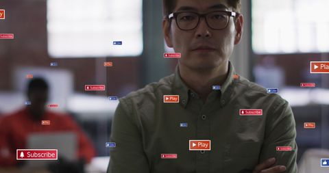 Asian Businessman with Social Media Interaction Icons in Office Setting