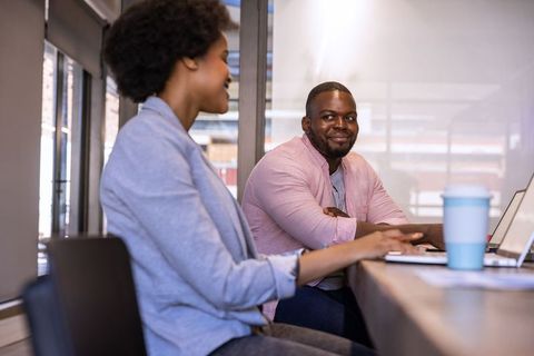 African American Professionals Collaborating in Modern Office with Technology