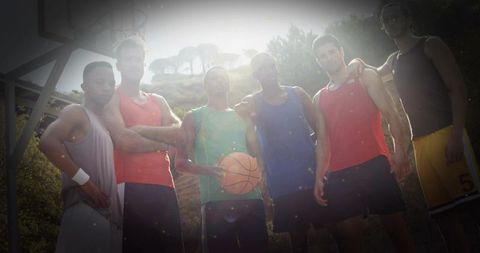 Diverse basketball team unity at dawn on outdoor court